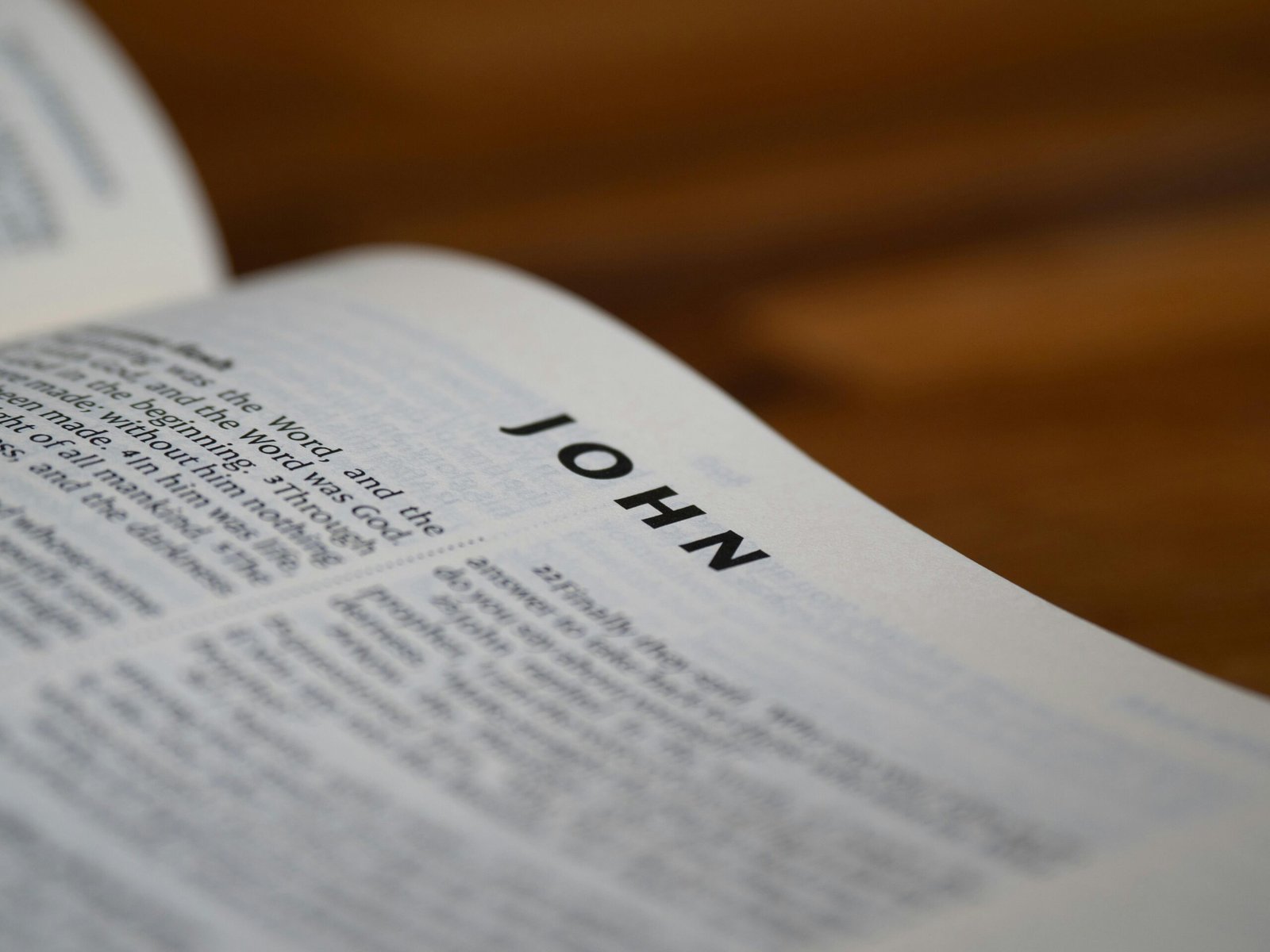 Detailed close-up of the Bible open to the Gospel of John with blurred background.
